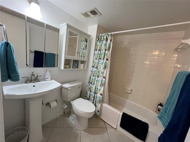 bathroom featuring tile patterned flooring, shower / bathtub combination with curtain, and toilet