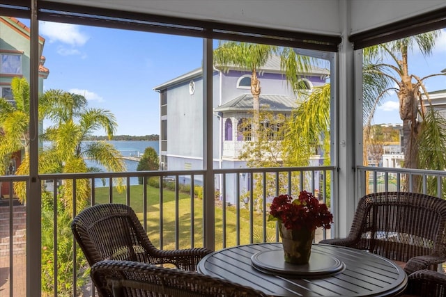 sunroom / solarium with a water view