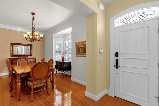 dining space with hardwood / wood-style floors, a chandelier, and ornamental molding