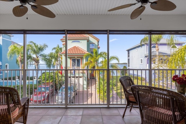 sunroom featuring ceiling fan