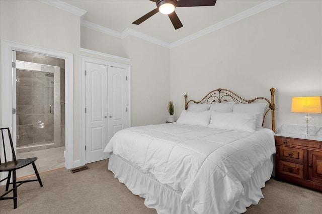 carpeted bedroom with ensuite bathroom, a closet, ceiling fan, and ornamental molding