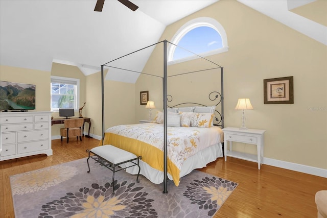 bedroom with ceiling fan, wood-type flooring, and lofted ceiling