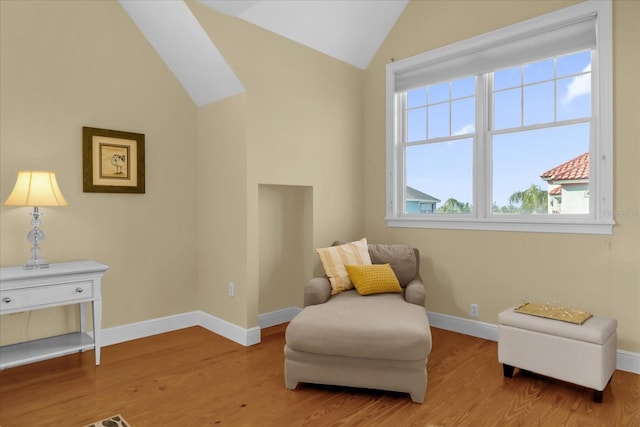 living area with lofted ceiling and light wood-type flooring