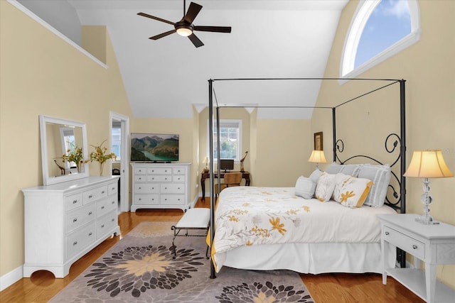 bedroom with ceiling fan, light wood-type flooring, and high vaulted ceiling