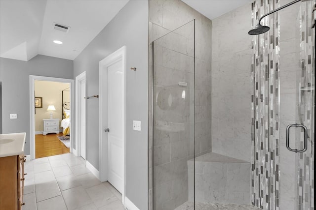 bathroom featuring tile patterned flooring, vanity, and a shower with shower door