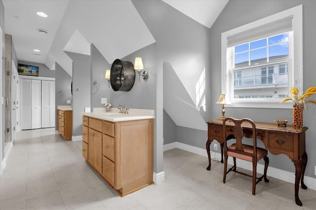 bathroom featuring vanity and vaulted ceiling