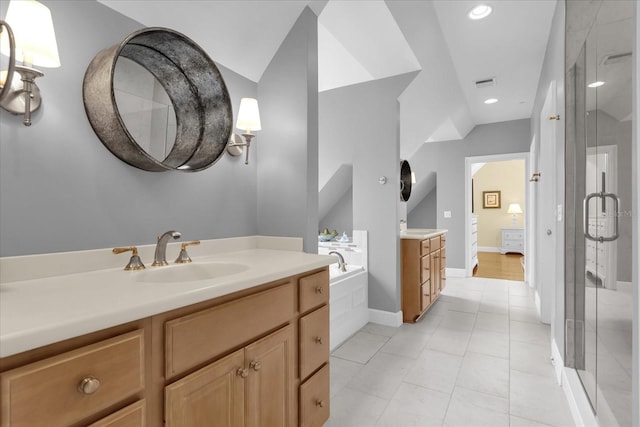 bathroom featuring tile patterned flooring, vanity, and plus walk in shower