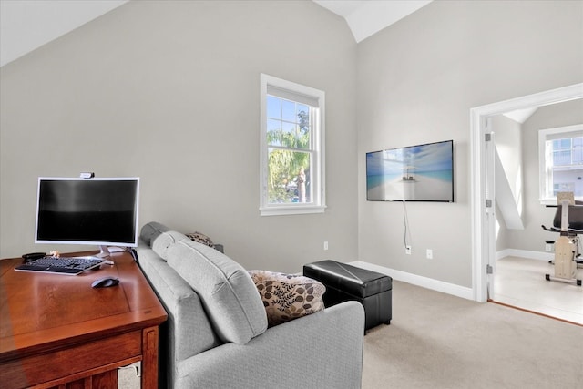 carpeted living room with lofted ceiling