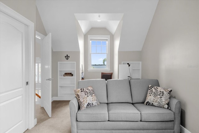 carpeted living room featuring vaulted ceiling