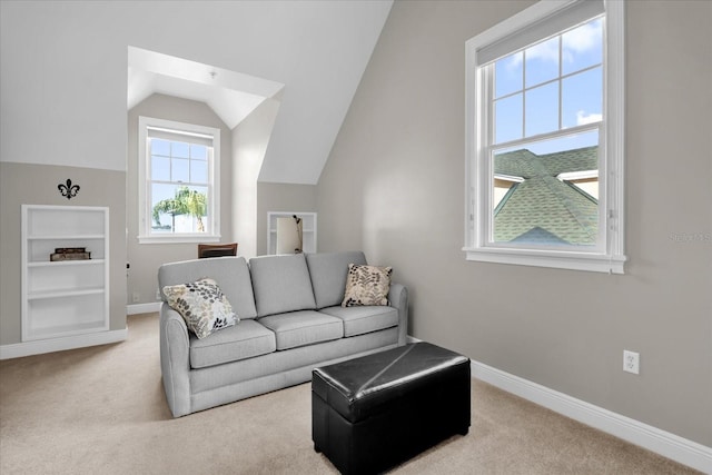 living room featuring light carpet, vaulted ceiling, and built in features