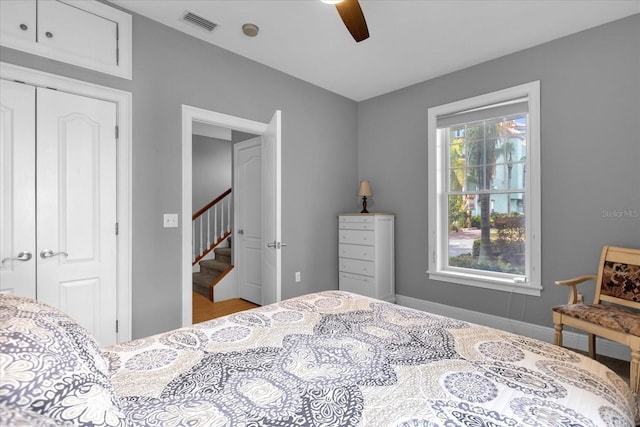 bedroom with ceiling fan and a closet