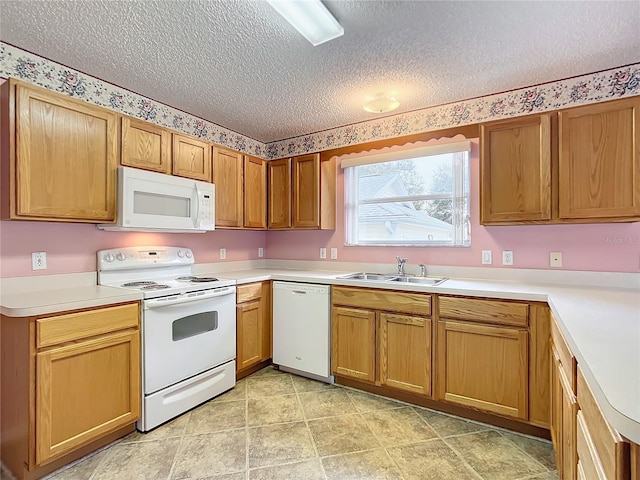 kitchen with a textured ceiling, sink, and white appliances