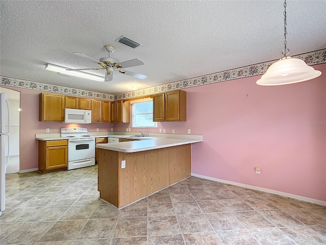 kitchen with white appliances, hanging light fixtures, ceiling fan, a textured ceiling, and kitchen peninsula