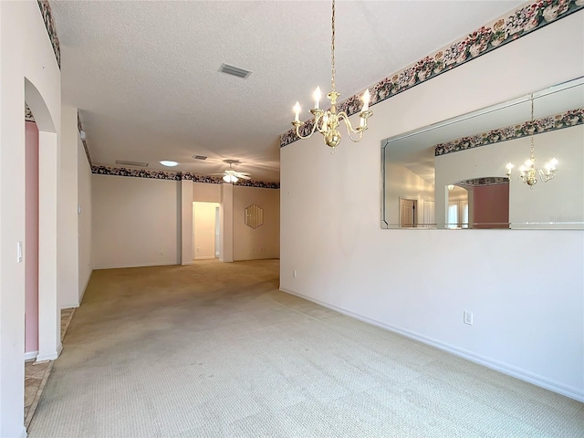 unfurnished room with ceiling fan, light carpet, and a textured ceiling