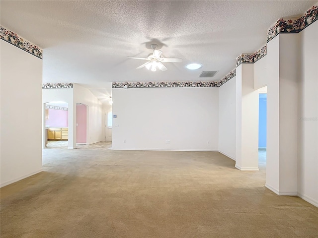 carpeted empty room with a textured ceiling and ceiling fan