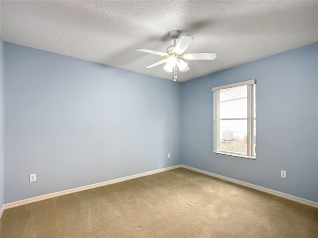 empty room with ceiling fan, carpet floors, and a textured ceiling