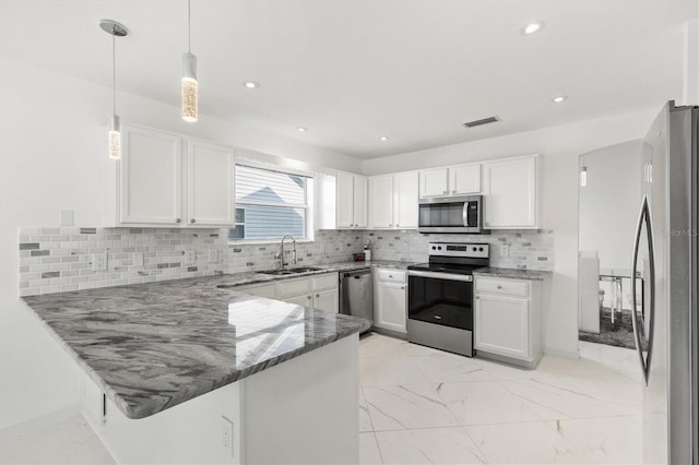 kitchen with kitchen peninsula, decorative backsplash, stainless steel appliances, sink, and white cabinets