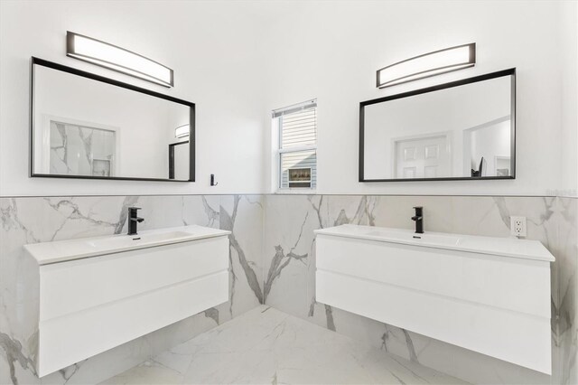 bathroom featuring vanity and tile walls