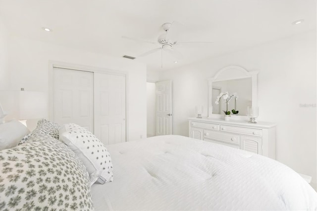 bedroom with ceiling fan and a closet