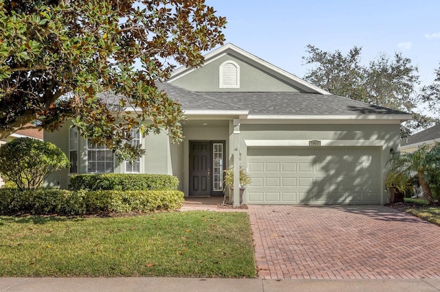 view of front of property with a garage and a front lawn