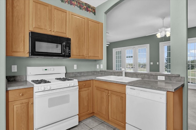 kitchen with kitchen peninsula, white appliances, ceiling fan, sink, and light tile patterned floors