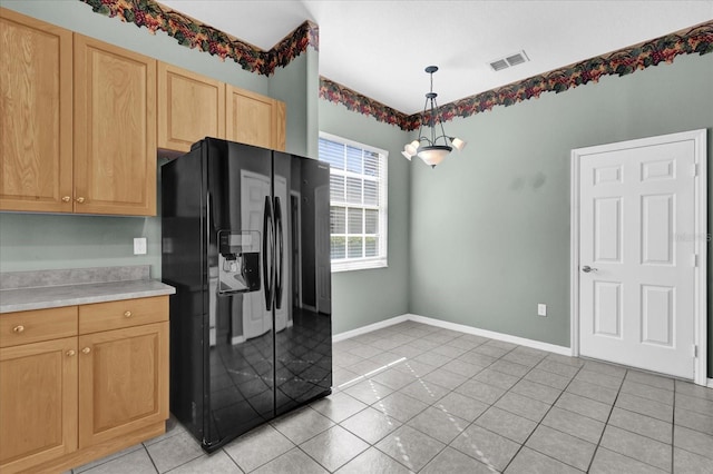 kitchen featuring light brown cabinetry, black refrigerator with ice dispenser, pendant lighting, light tile patterned floors, and a chandelier