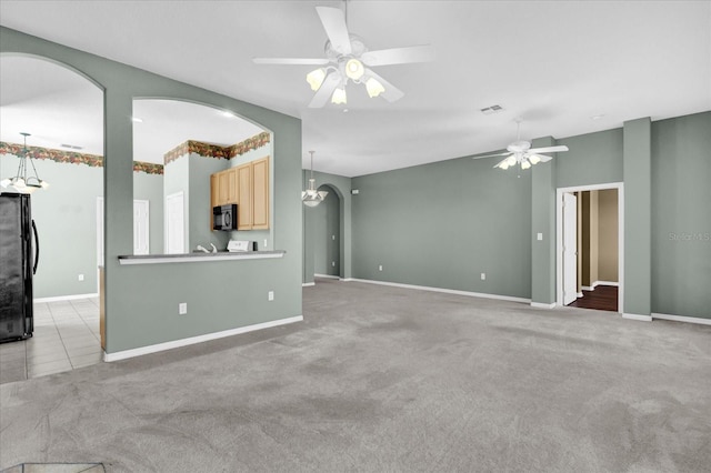 unfurnished living room with light carpet and ceiling fan