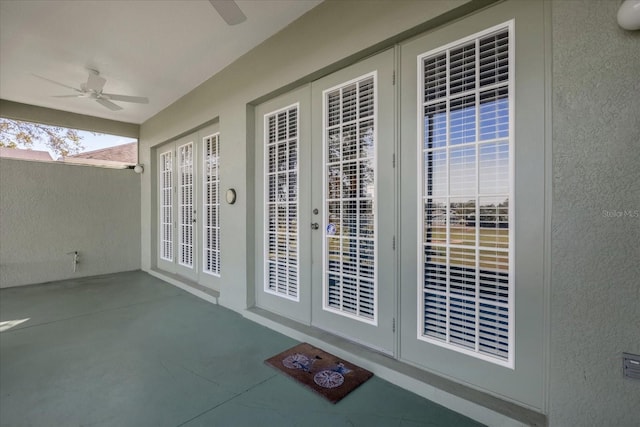 entrance to property with ceiling fan and french doors