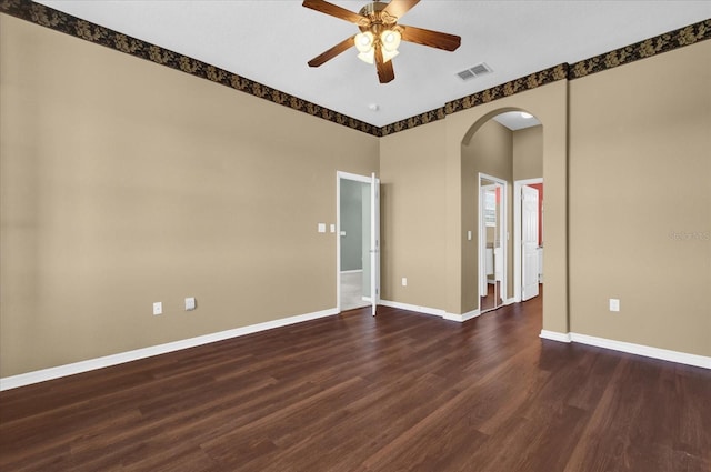 spare room featuring ceiling fan and dark hardwood / wood-style flooring