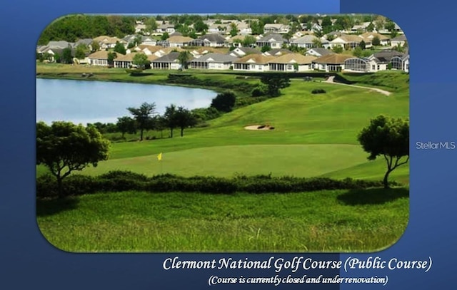 view of property's community featuring a water view and a lawn