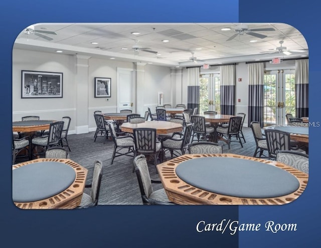 dining room featuring carpet flooring, french doors, and a drop ceiling