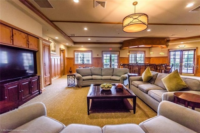 living room with light colored carpet and ornamental molding