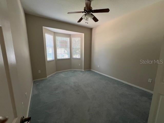 1063 Mesa Verde Ct, Clermont, FL 34711 - spare room with baseboards, a ceiling fan, and carpet flooring