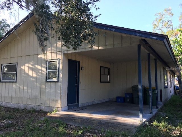 back of house featuring a carport