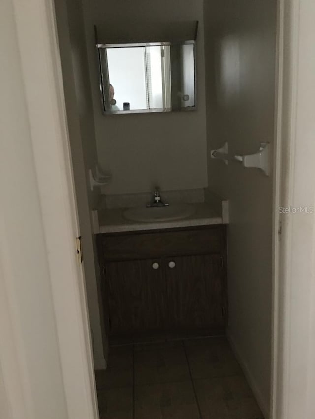 bathroom featuring tile patterned flooring and vanity