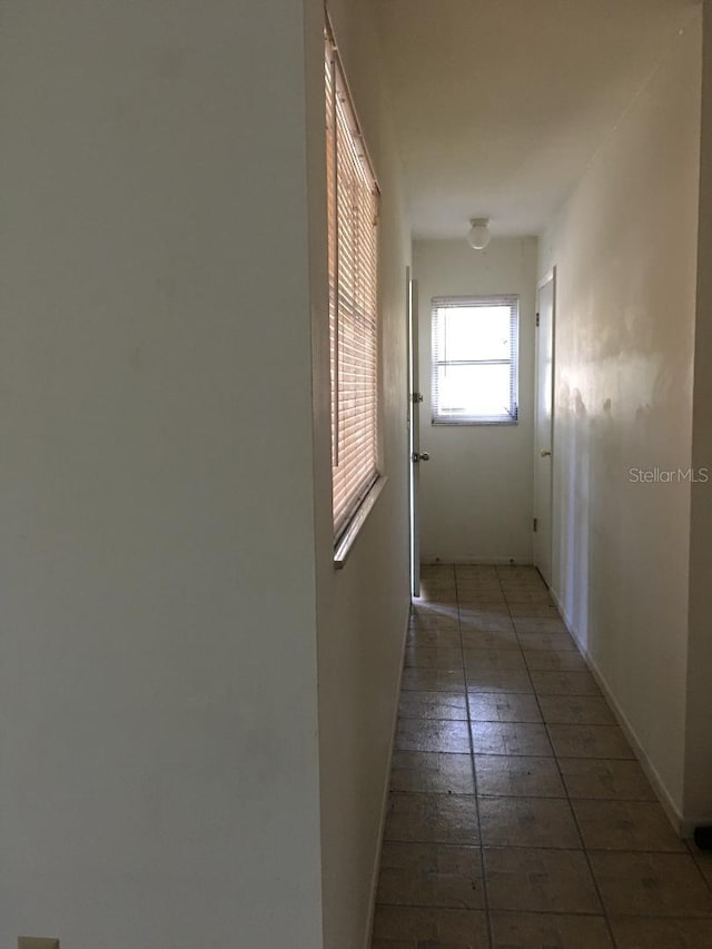 5100 Rilma Ave, Sarasota, FL 34234 - hallway featuring baseboards and tile patterned floors