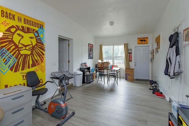 misc room with light hardwood / wood-style flooring and lofted ceiling