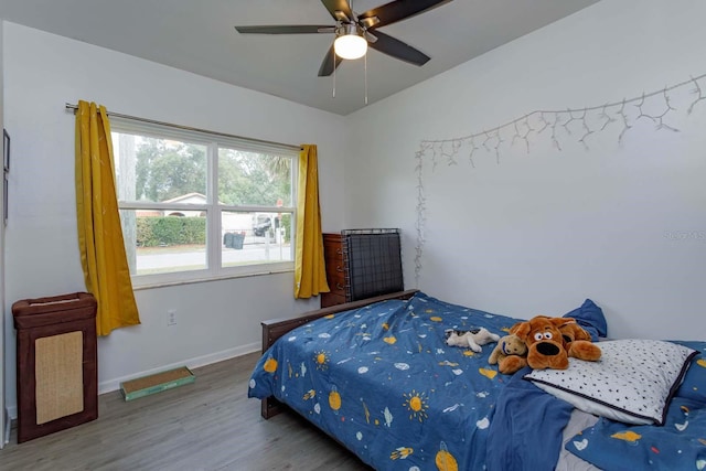 bedroom with ceiling fan and hardwood / wood-style flooring