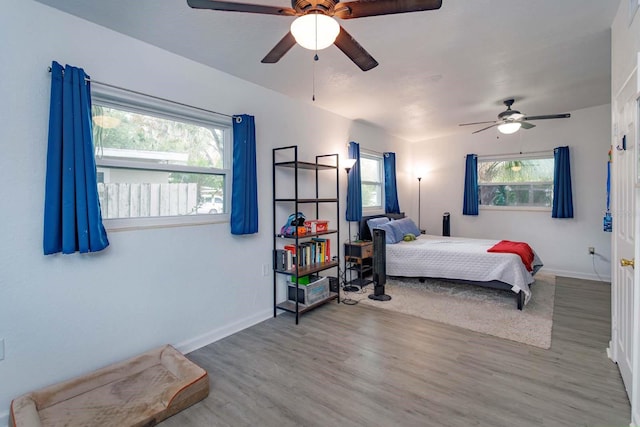 bedroom with ceiling fan and wood-type flooring