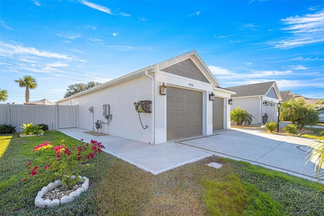 view of property exterior featuring a yard and a garage