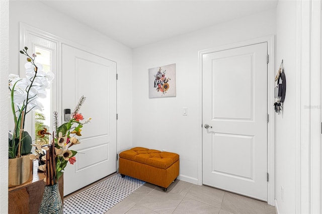 foyer entrance featuring light tile patterned floors