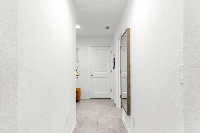 hallway featuring light tile patterned flooring