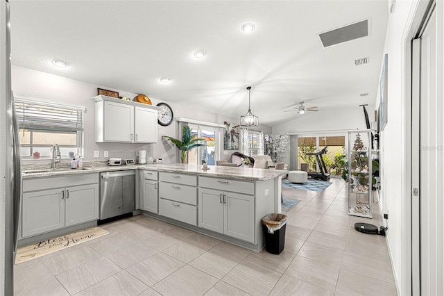 kitchen featuring ceiling fan, sink, stainless steel dishwasher, kitchen peninsula, and vaulted ceiling