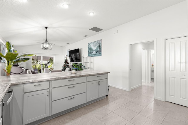 kitchen with gray cabinets, light tile patterned floors, hanging light fixtures, and vaulted ceiling