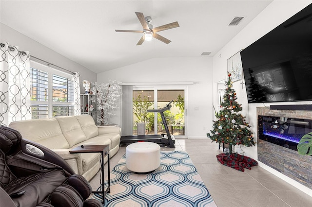 tiled living room featuring ceiling fan, lofted ceiling, and a wealth of natural light