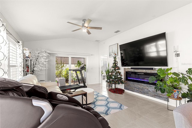 tiled living room with ceiling fan and vaulted ceiling