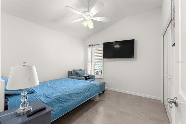 bedroom featuring a closet, vaulted ceiling, and ceiling fan