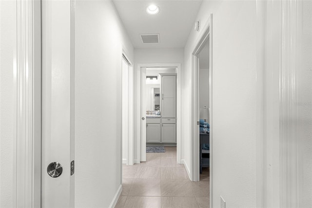 hall with light tile patterned flooring