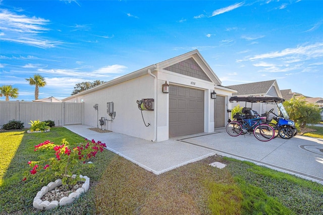 view of side of home featuring a yard and a garage