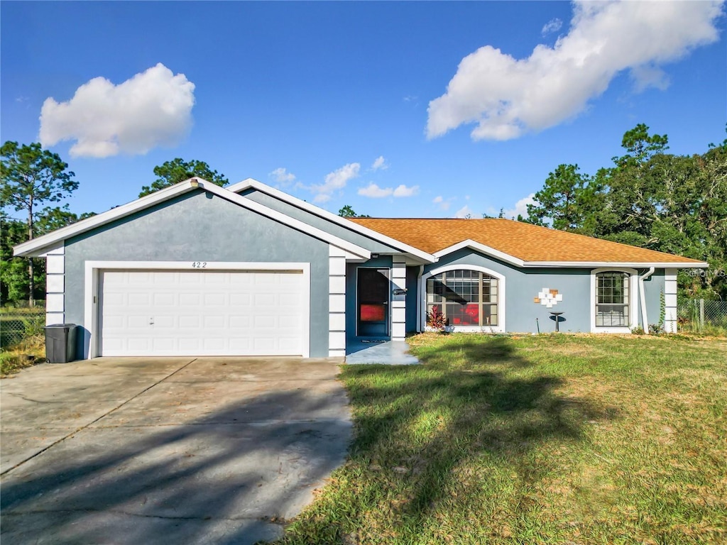 ranch-style house with a garage and a front yard